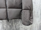 Long padded jacket with front pocket opening and drawcord hem, dark gray