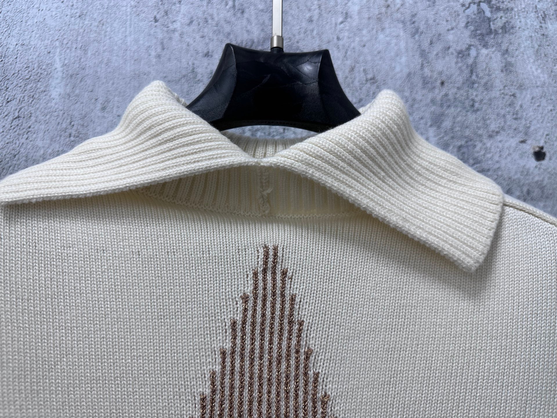 Dior knit sweater neckline close-up with ribbed collar and star motif