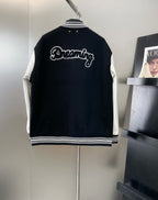 Louis Vuitton long varsity jacket, back view in black with white script “Dreaming”