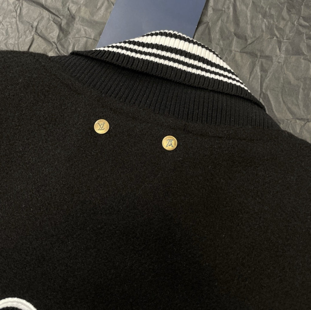 Louis Vuitton long varsity jacket ribbed collar close-up with striped knit and gold-toned buttons