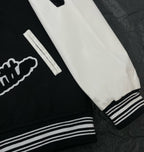 Louis Vuitton long varsity jacket sleeve cuff close-up, white panel with striped ribbed hem