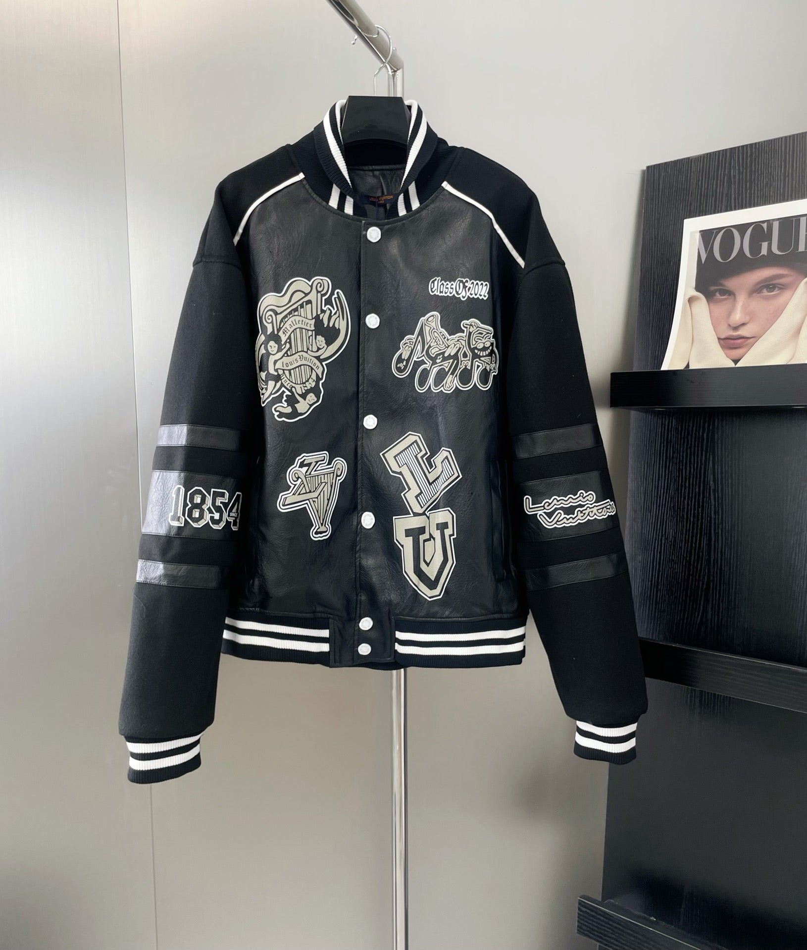 Louis Vuitton leather-look varsity jacket in dark navy with white striping and patches