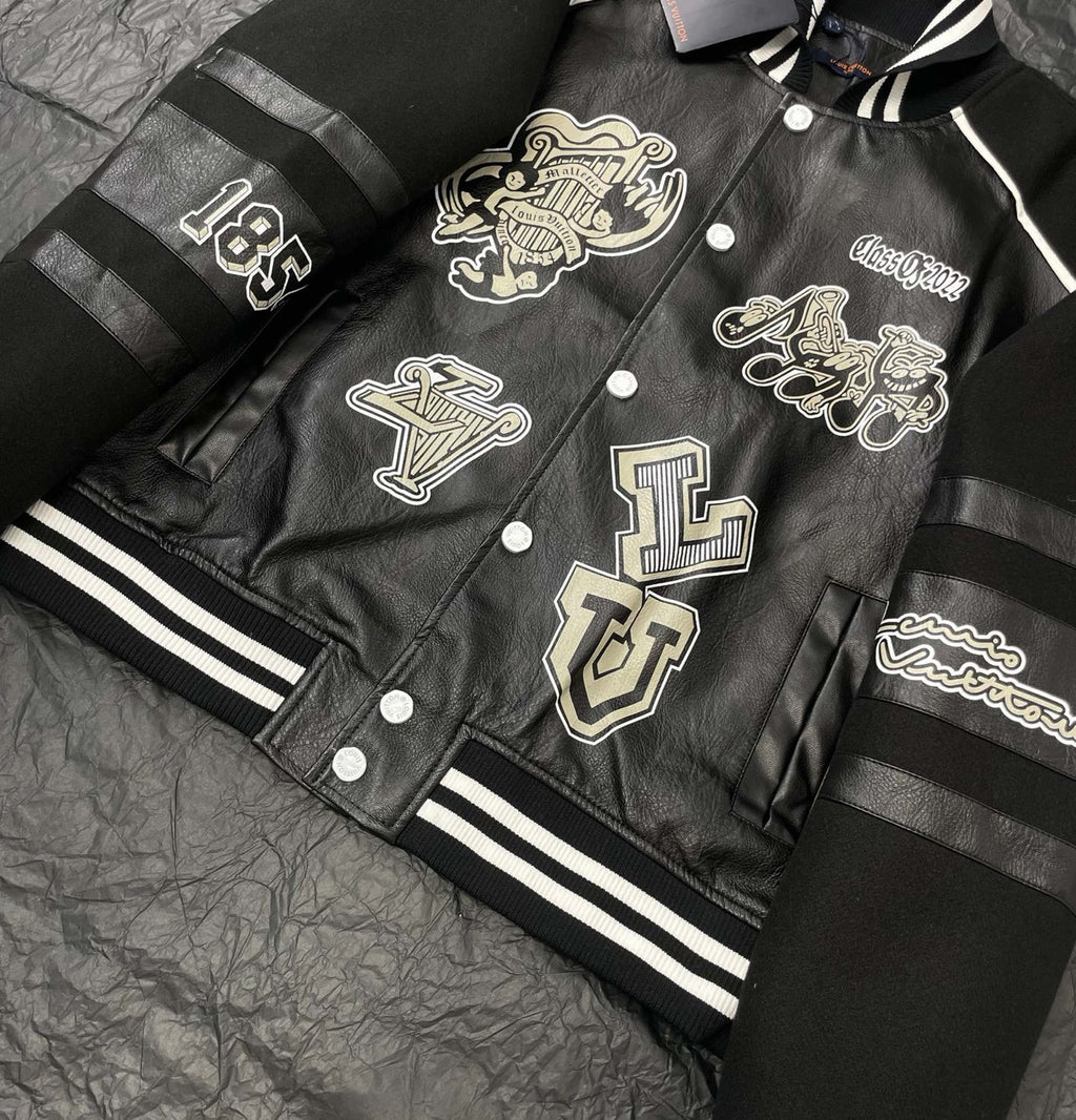 Louis Vuitton leather-look varsity jacket laid flat with front patch graphics and striped cuffs