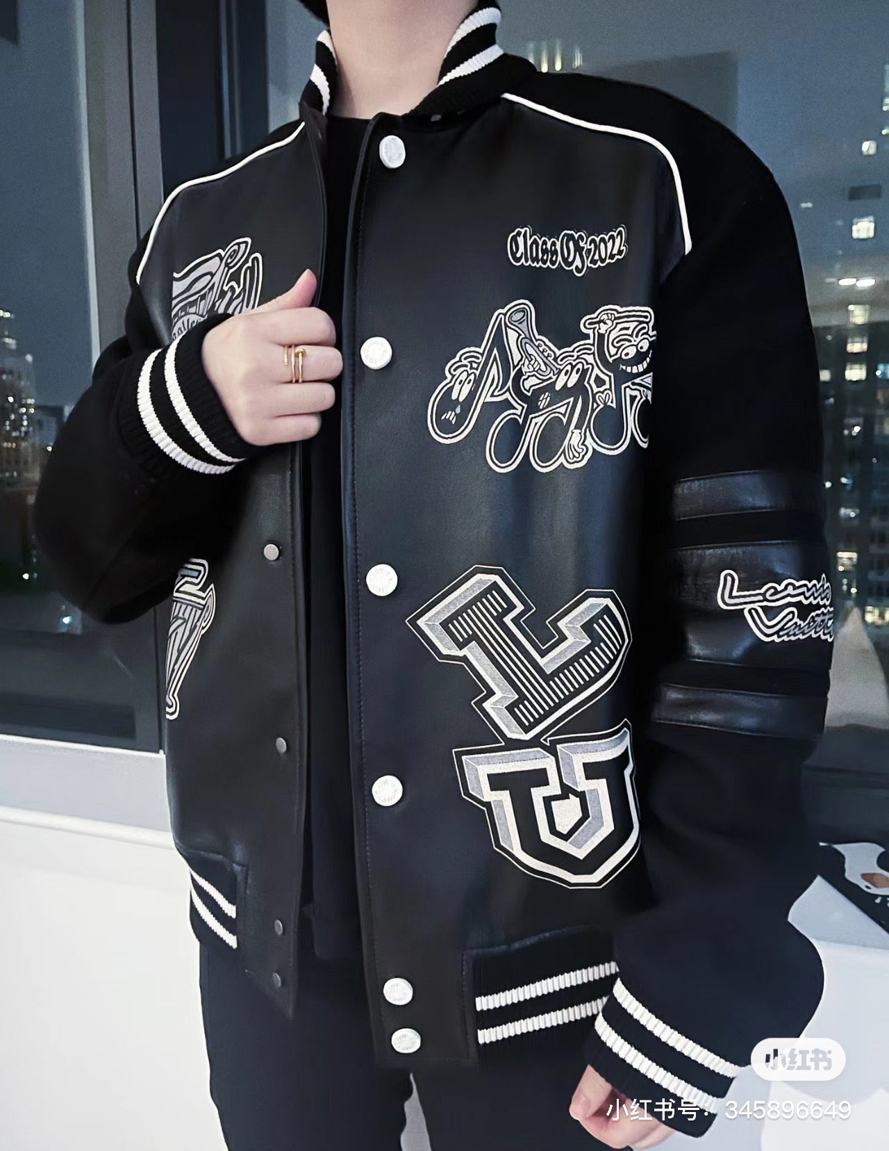Louis Vuitton leather-look varsity jacket on model, button front and embroidered chest patches