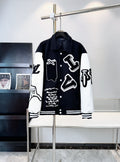 Black and white varsity-style button-up jacket with bold graphic front print and ribbed cuffs