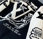 Close-up of jacket back graphic with text details on black panel and white sleeve