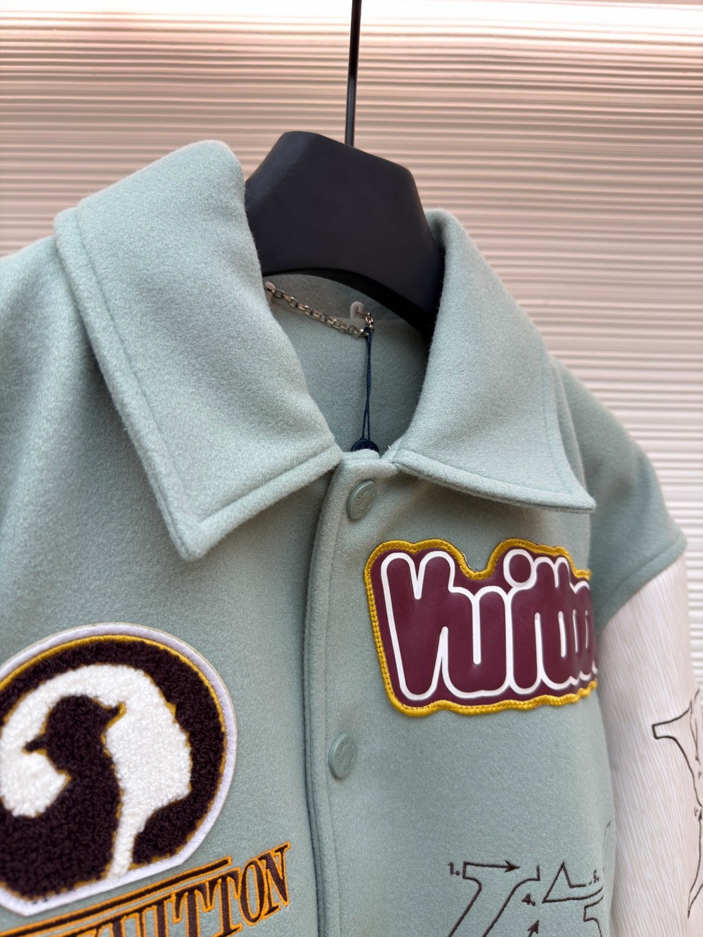 Light blue jacket neckline, embroidered colorful logo patch on chest