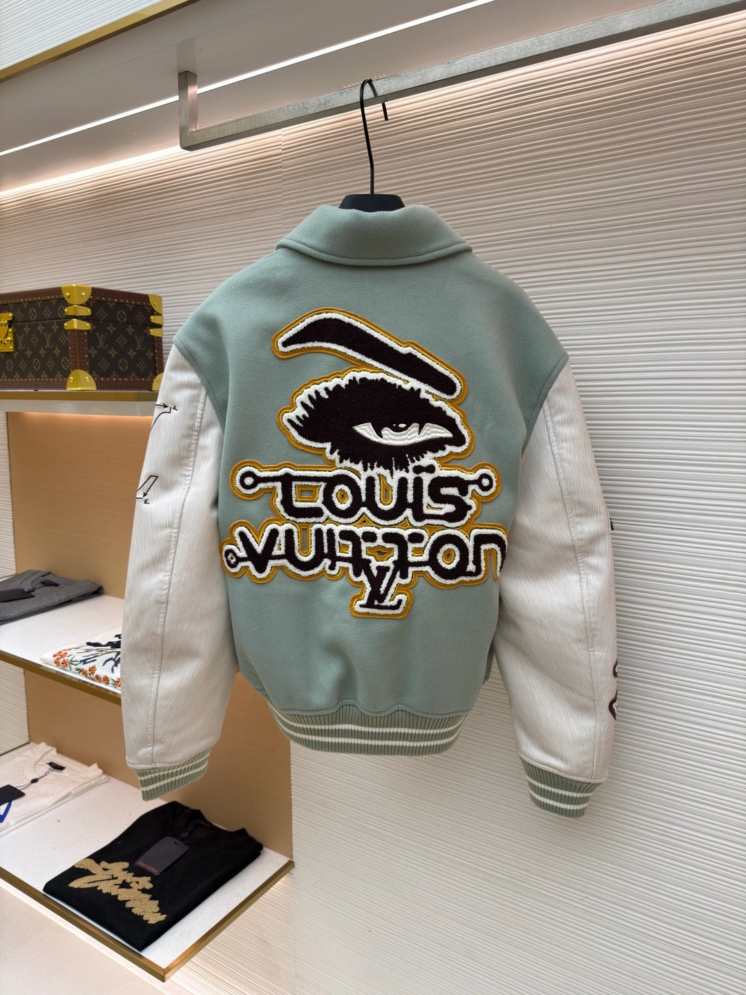 Long-sleeve light blue jacket, back with large eye patch and colorful embroidery