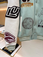Light blue jacket sleeve, black-and-white patch graphic with ribbed hem trim
