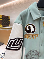Light blue varsity jacket, front with black-and-white patch and ribbed button placket