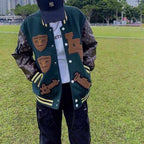 Green varsity jacket front view with button front, patches, and striped cuffs and collar