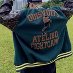 Back of green varsity jacket with large brown text and cat patch, striped hem and cuffs