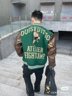 Green varsity jacket back view with Atelier Fightcamp text, striped hem, patterned sleeves