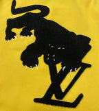 Yellow Louis Vuitton jacket with black cowboy silhouette graphic and L-style mark