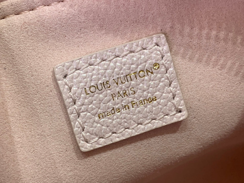 Louis Vuitton light pink bag leather label reading “LOUIS VUITTON PARIS made in France”