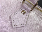 Louis Vuitton light pink bag close-up of embossed leather and stitched pocket detail