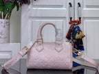 Louis Vuitton light pink mini bag with embossed monogram, front view with shoulder strap