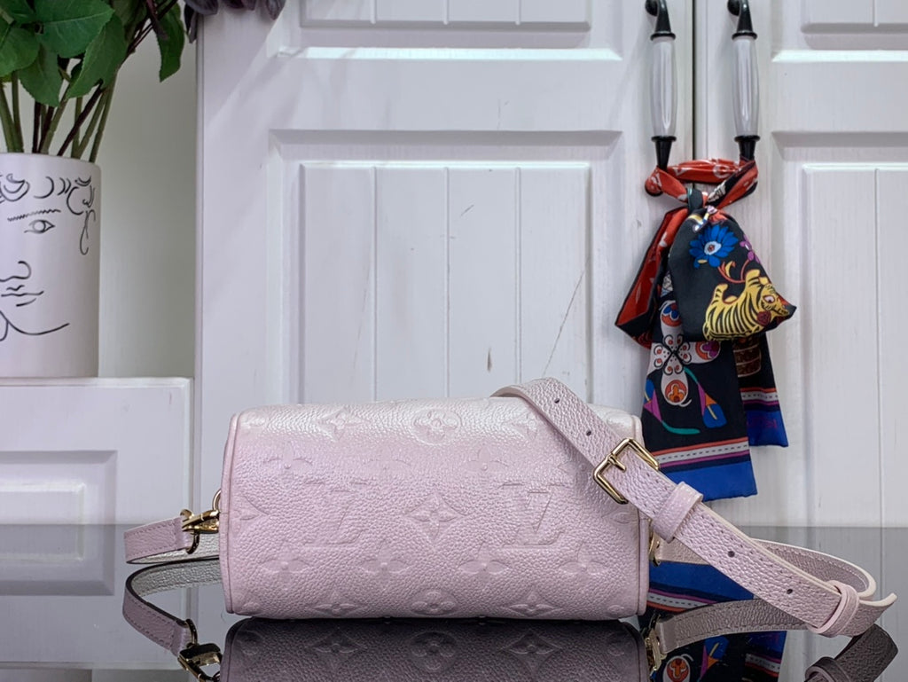 Louis Vuitton light pink mini bag with embossed monogram, long strap and side profile