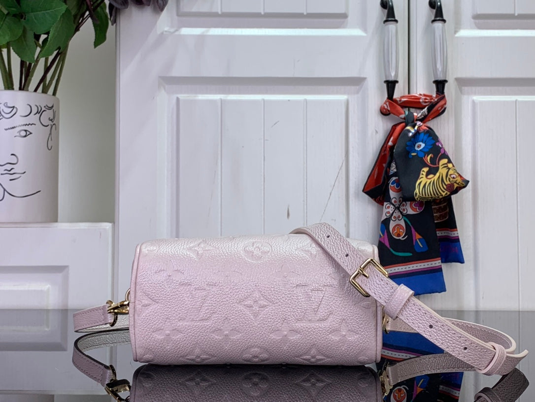 Louis Vuitton light pink mini bag with embossed monogram, long strap and side profile