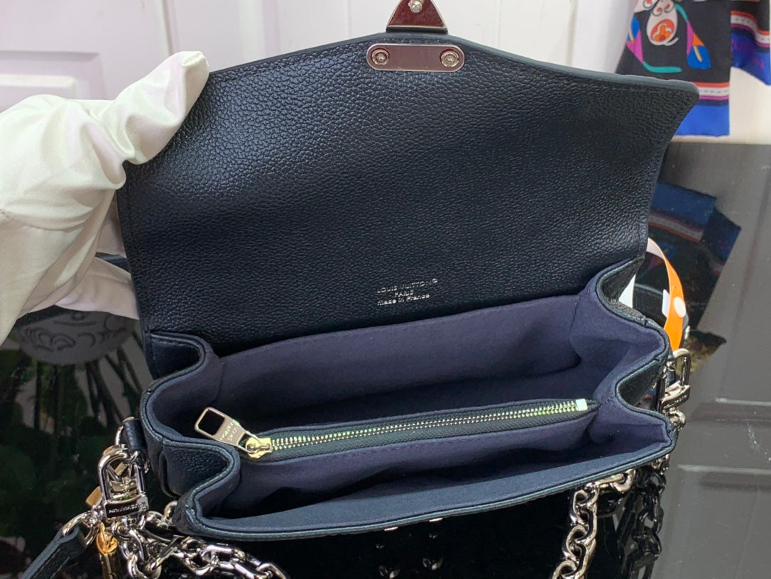 Dark teal flap bag interior with zipper pocket and gold-tone chain strap