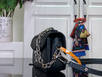 Dark teal leather shoulder bag with top opening, chain strap, and front hardware