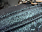 Embossed leather strap close-up with 'LOUIS VUITTON' text and visible stitching