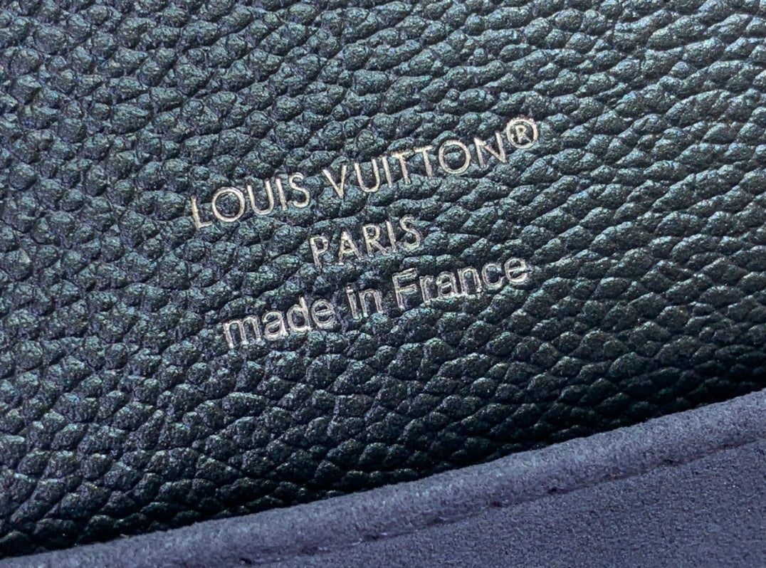 Embossed logo text on dark teal pebbled leather: 'LOUIS VUITTON' and 'made in France'