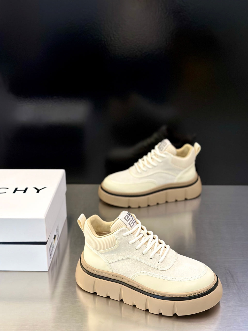 Givenchy cream lace-up sneakers shown from side, with logo heel patch and platform sole