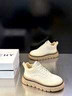 Givenchy cream lace-up sneakers shown from side, with logo heel patch and platform sole