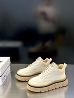 Givenchy cream low-top sneakers with lace-up front, logo detailing, and treaded platform sole