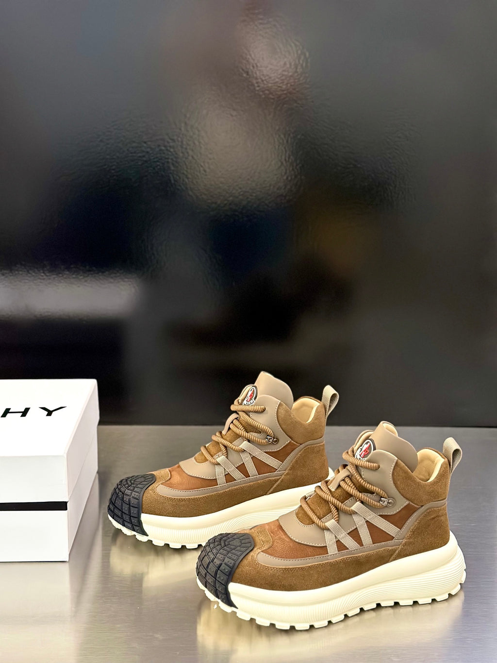 Moncler sneakers pair, tan suede uppers with beige laces and white ridged platform sole