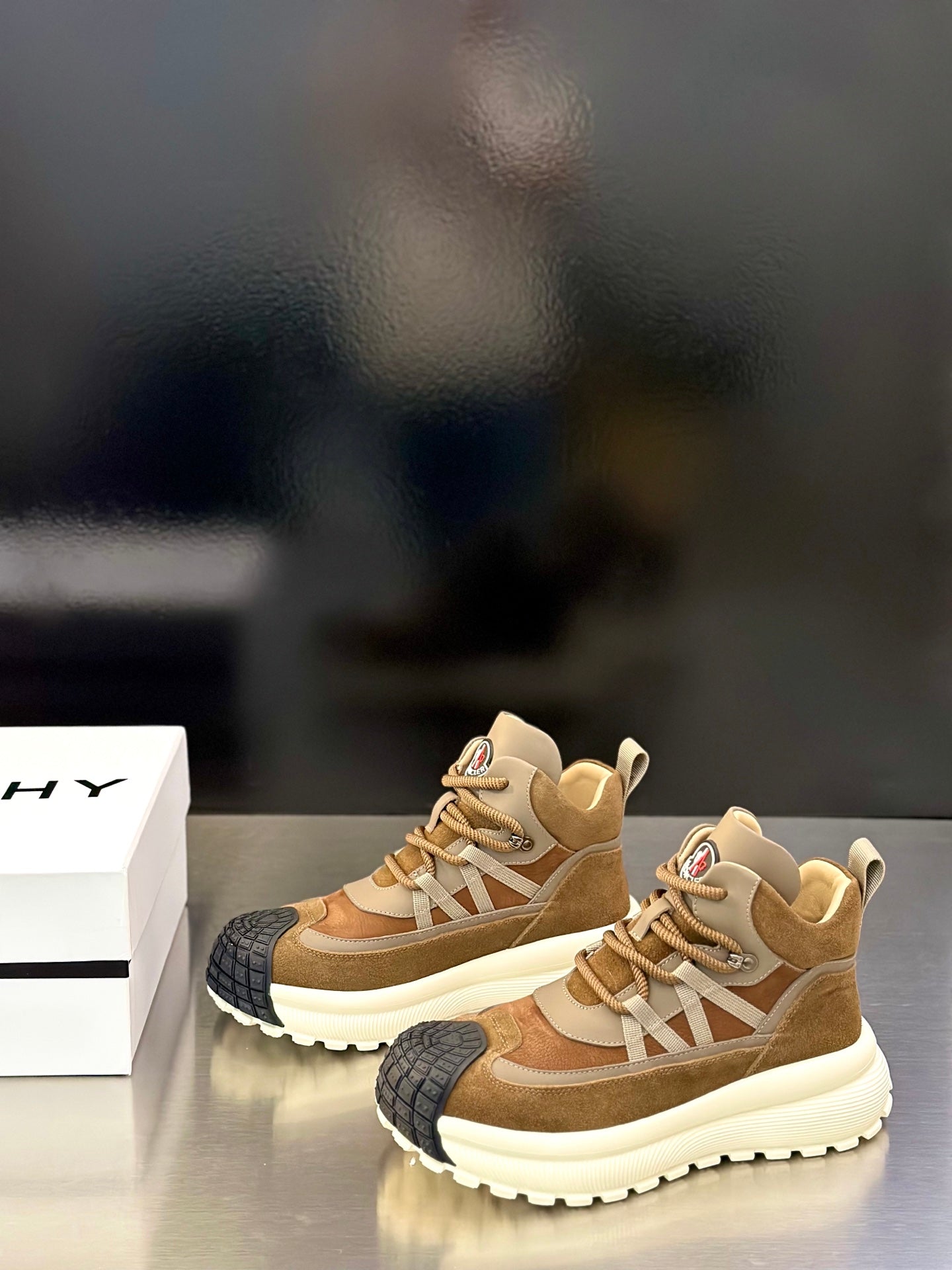 Moncler sneakers pair, tan suede uppers with beige laces and white ridged platform sole
