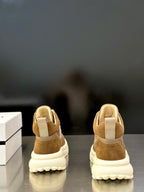 Moncler sneakers heel view in tan suede with padded back and chunky white sole