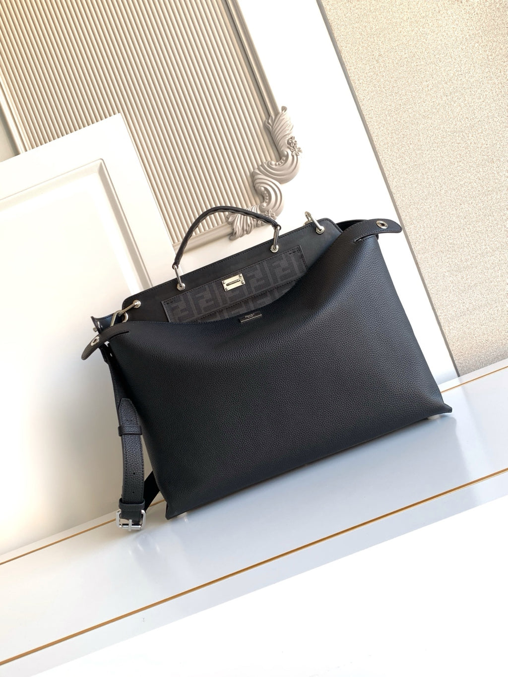 Fendi handbag with front logo panel, top handles, and shoulder strap