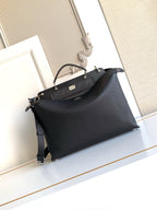 Fendi handbag with front logo panel, top handles, and shoulder strap