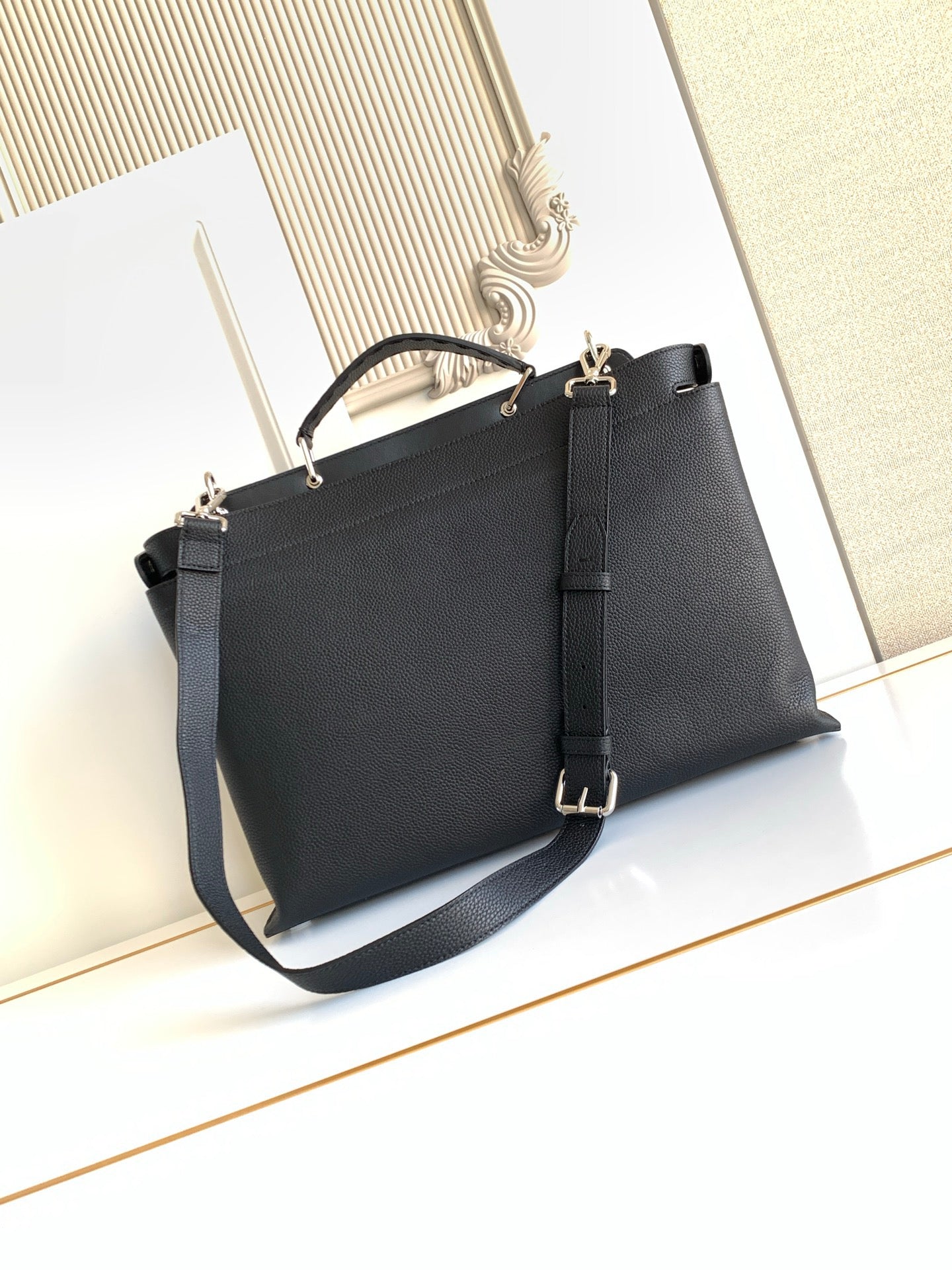 Fendi handbag with structured shape, top handles, and crossbody strap