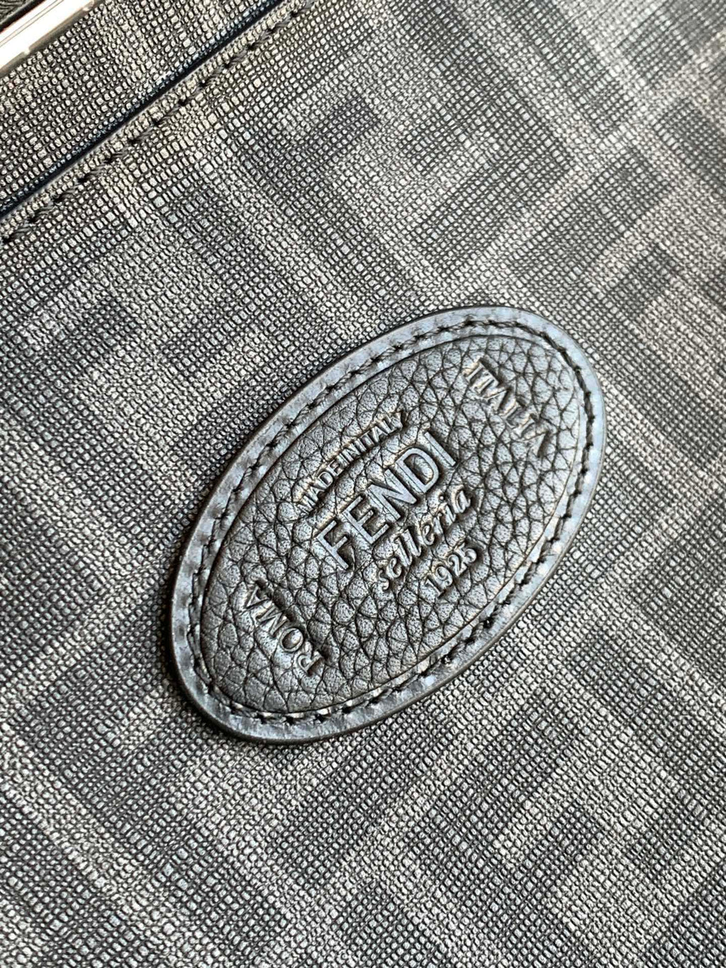 Fendi handbag close-up of embossed logo patch on textured leather