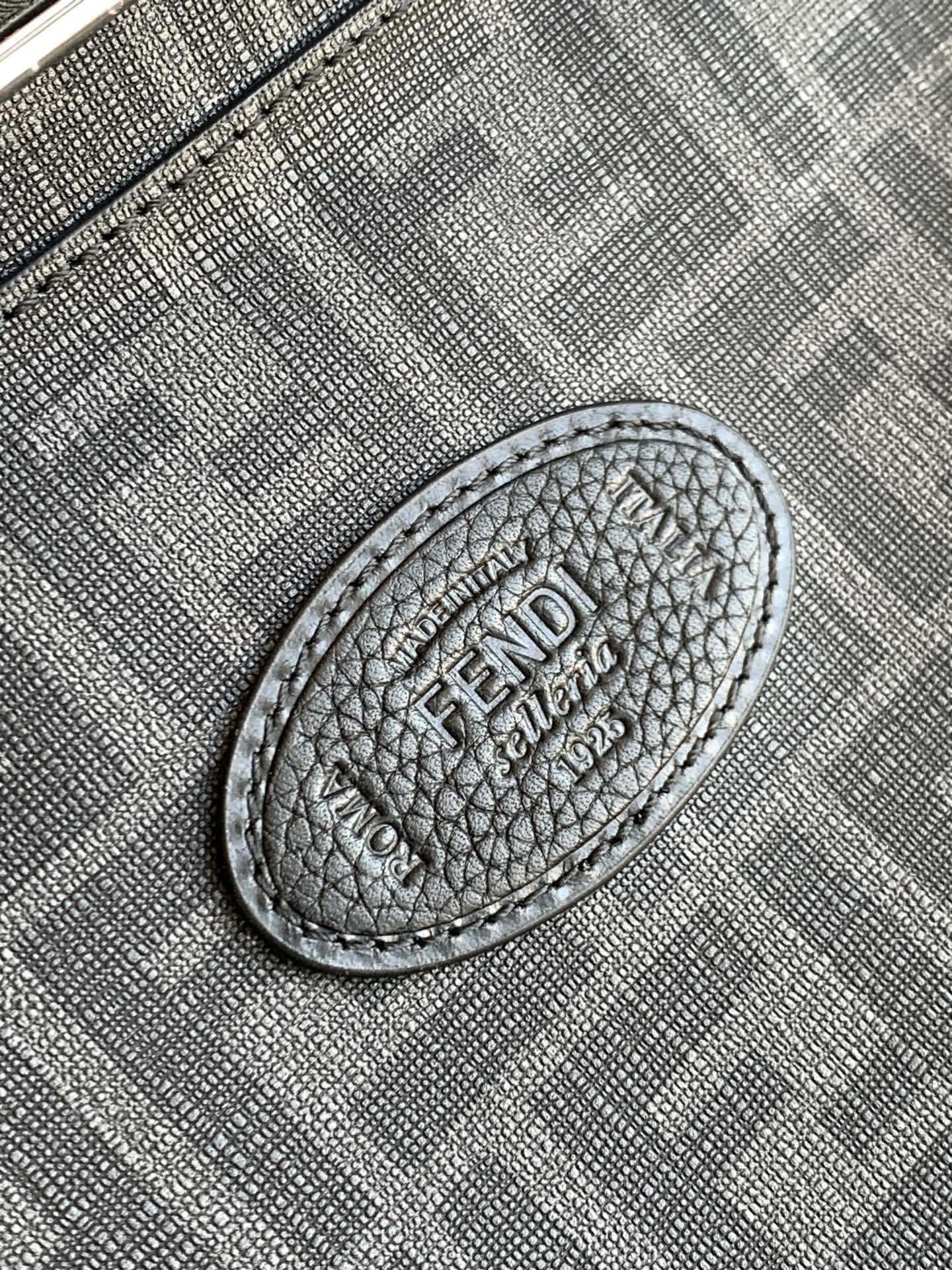 Fendi handbag close-up of embossed logo patch on textured leather