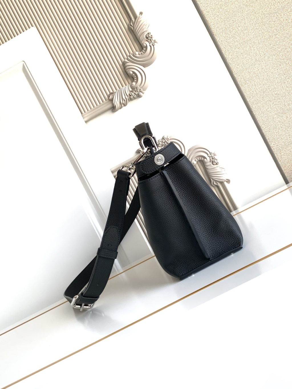 Fendi structured leather handbag with crossbody strap and front flap, black.