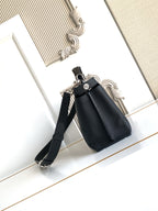 Fendi structured leather handbag with crossbody strap and front flap, black.