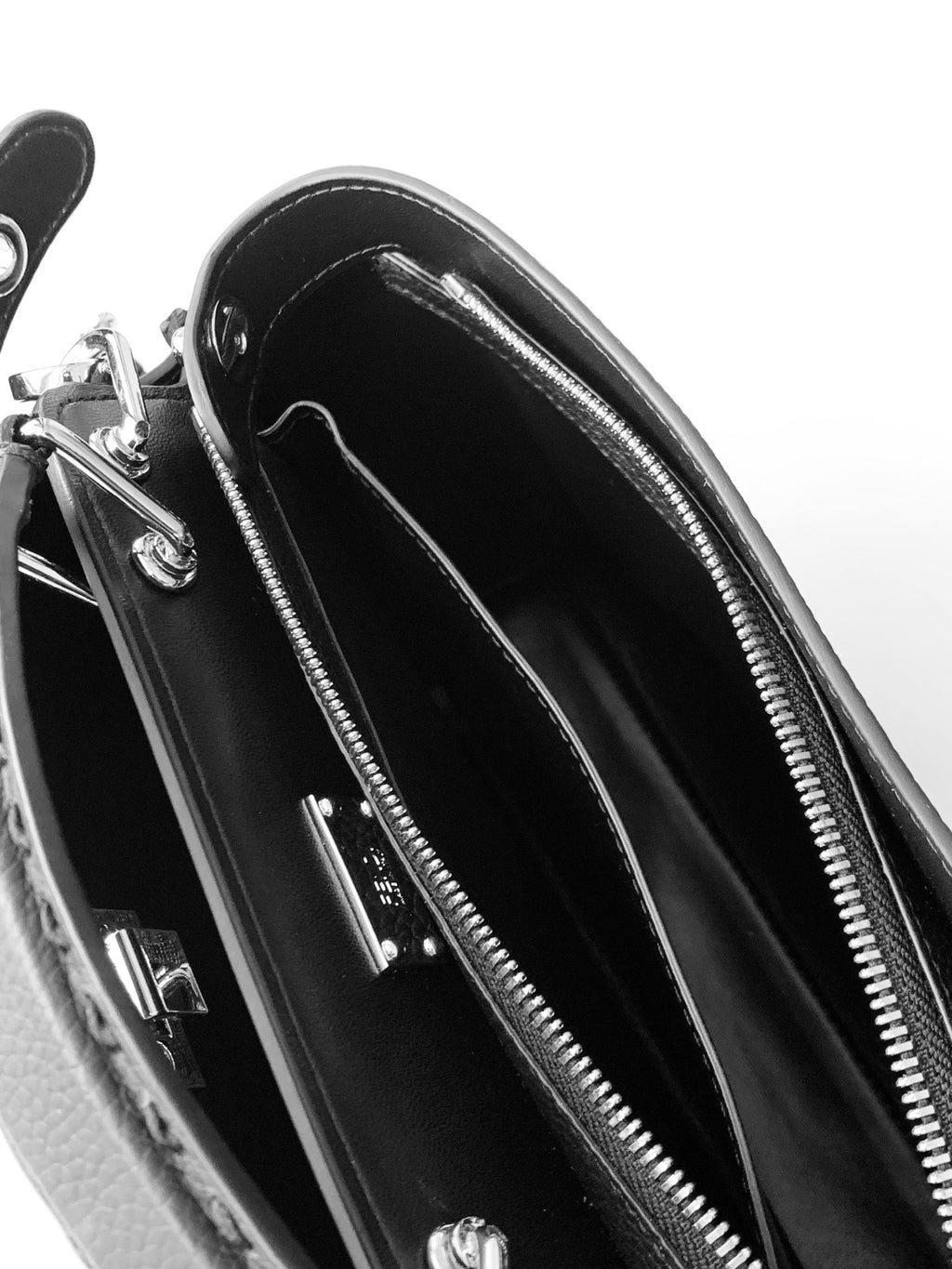 Fendi leather handbag interior with zip pockets and smooth black lining.