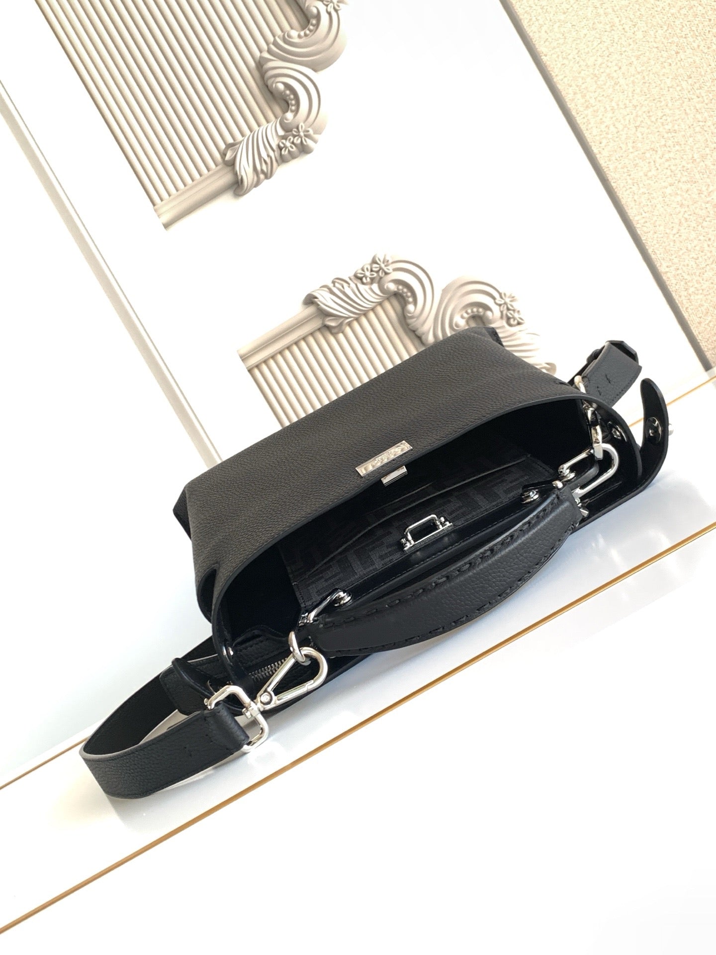 Fendi leather handbag with crossbody strap and zipper closure, black.
