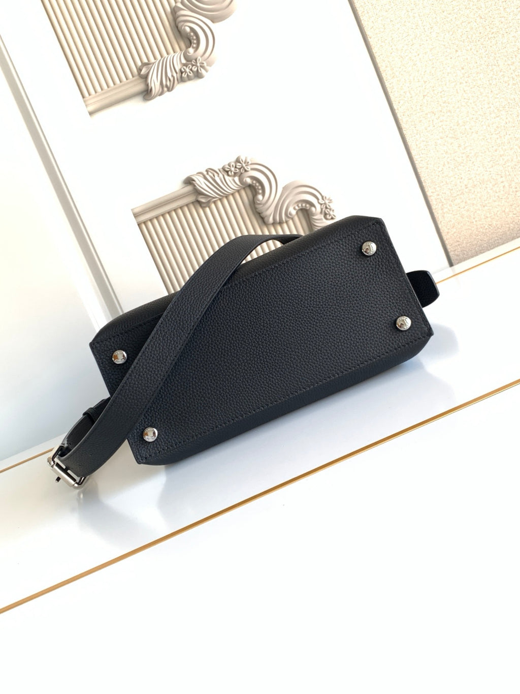 Fendi leather handbag with front snap buttons and shoulder strap, black.