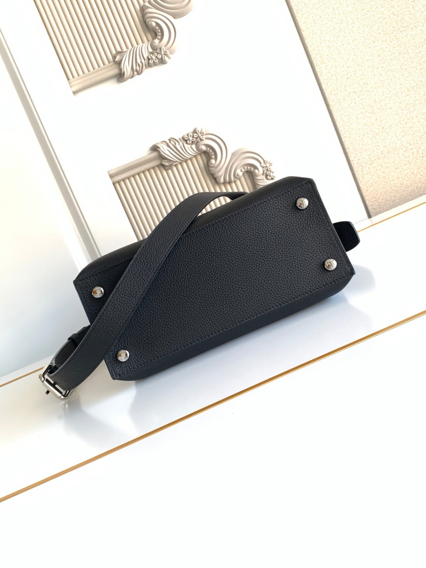 Fendi leather handbag with front snap buttons and shoulder strap, black.