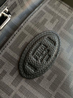 Fendi oval logo patch on textured interior pocket, black.