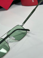 Prada sunglasses close-up of green temple arm and green tinted lens