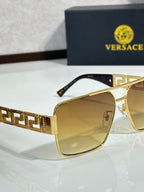 Versace sunglasses with gold frames and amber tinted lenses