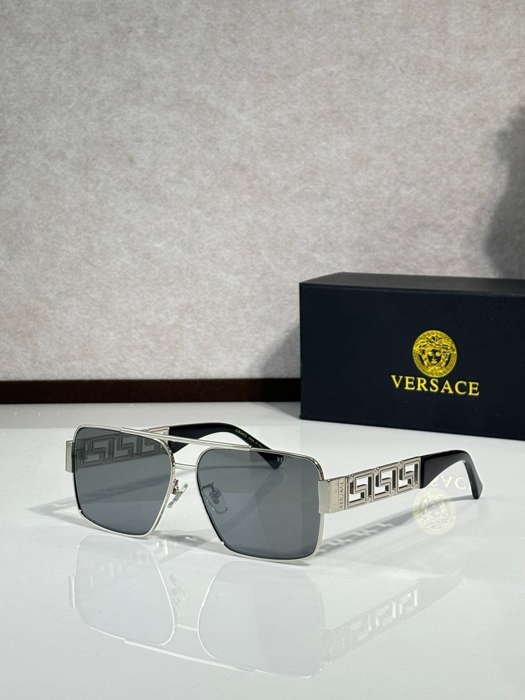 Versace sunglasses with silver frames and dark gray lenses