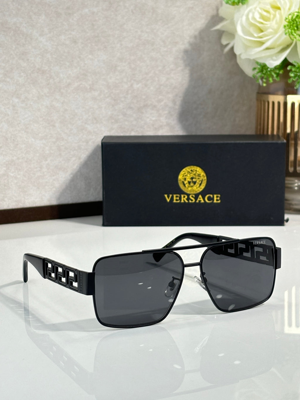 Versace sunglasses with black frames and dark lenses