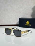 Versace sunglasses with gold-and-black frames and dark gray lenses